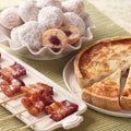 Brunch Favorites Sampler, featuring Fruit-Filled French Beignets (top), Vanilla-Bourbon Bacon "Lollipops" (bottom left), and Quiche Lorraine (bottom right).